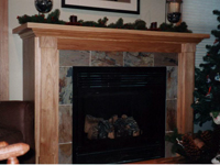A custom built fireplace surround designed and installed by Cabinet Innovations.