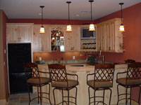 A custom built wet bar made out of birch wood by Cabinet Innovations.