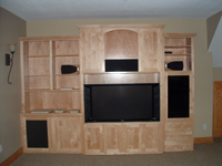 A custom designed and installed entertainment center by Cabinet Innovations.