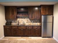 A custom built wet bar made out of birch wood by Cabinet Innovations.